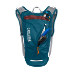 CamelBak Rogue Light 7 hydration backpack in moroccan blue with compartments open showing contents