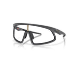 Oakley RSLV matte carbon sports sunglasses with clear photochromic lenses on white background