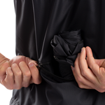 Close-up detail of black Pearl Izumi Quest Barrier jacket showing packable feature and storage pocket
