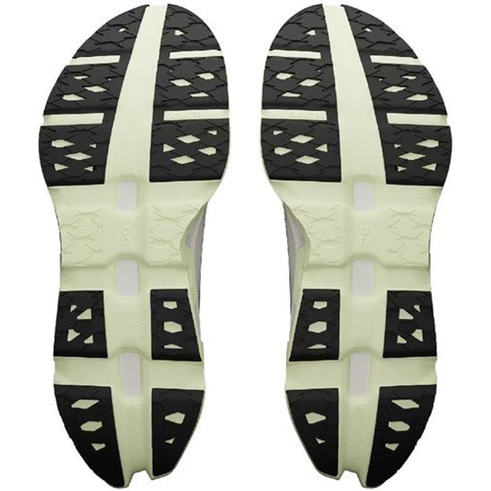 On Running Cloudmonster shoe soles showing ivory colored midsole with black rubber outsole tread pattern