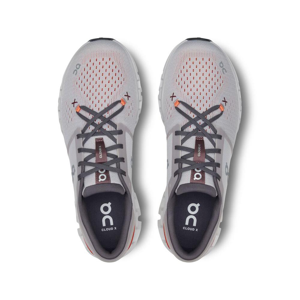 On Cloud X 4 running shoes in silver with orange flame accents, top view