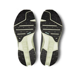 On Cloudsurfer trail running shoe soles showing black tread pattern with lime green midsole