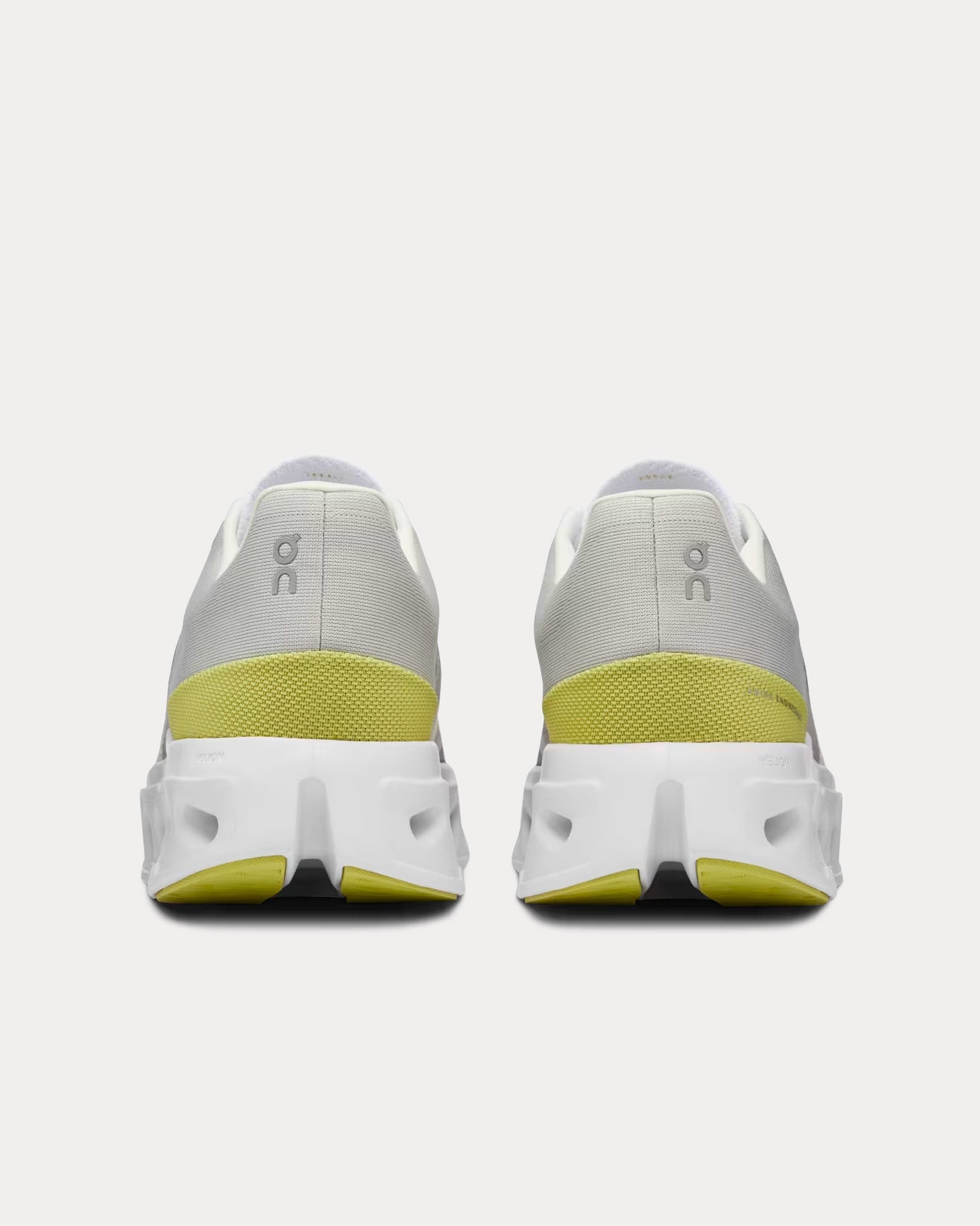 On Cloudeclipse running shoes rear view showing white gray upper with lime accents