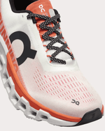 On Cloudmonster 2 running shoe in undyed white with orange zest accents