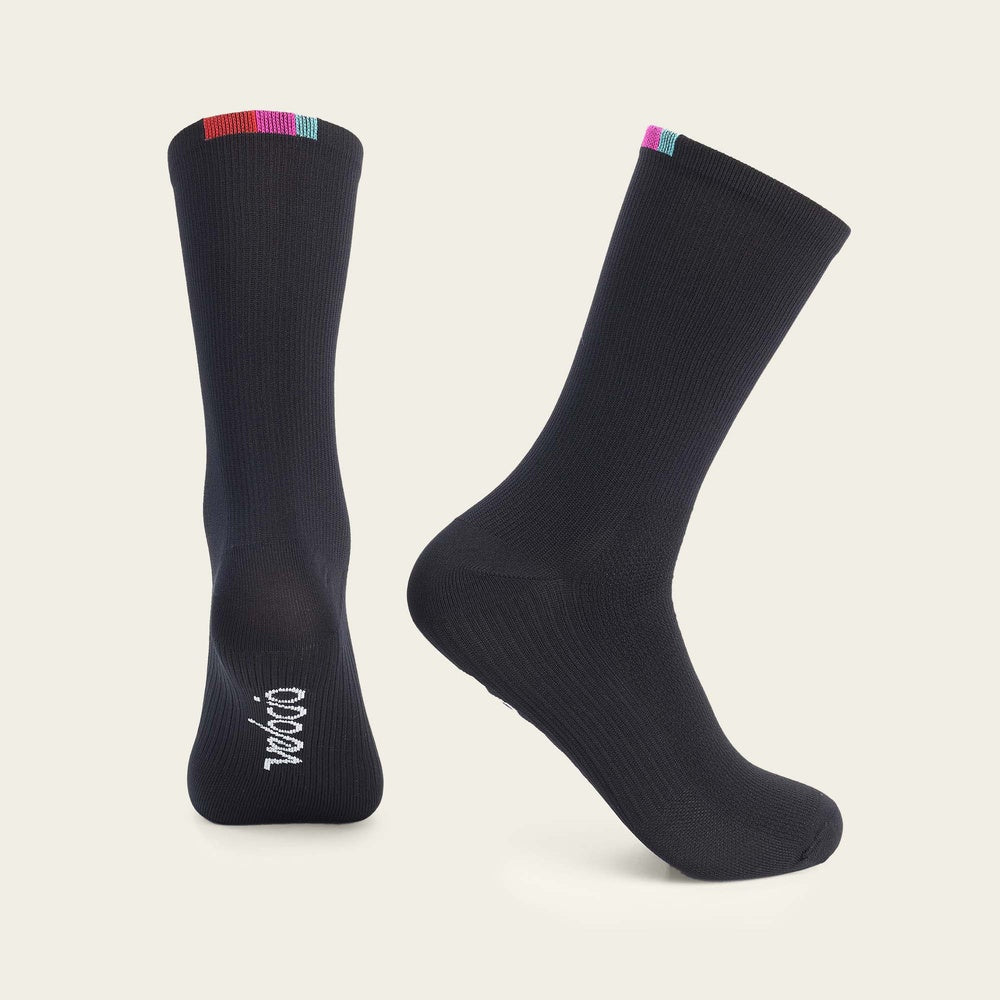 Velocio navy cycling socks with colorful striped cuff on clean background