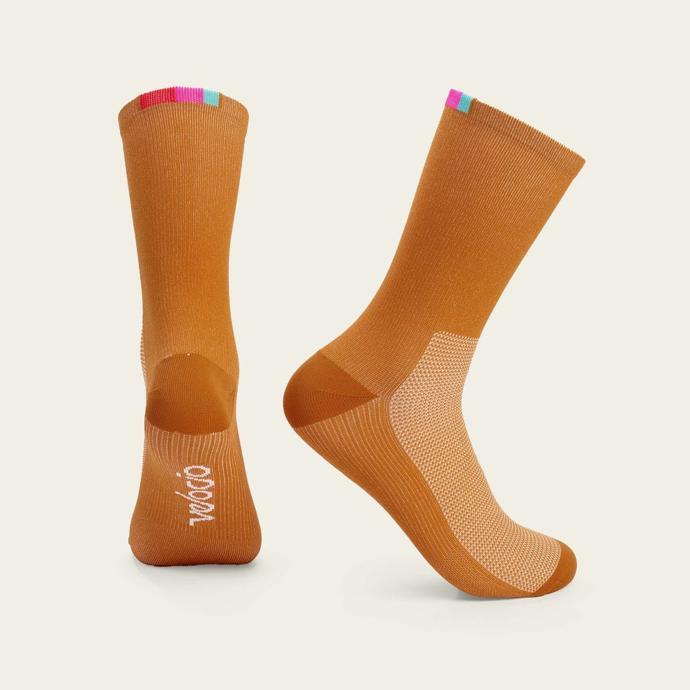 Orange Velocio cycling socks with colorful striped cuff and white logo