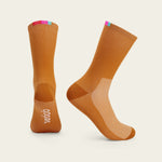 Velocio Terra orange cycling socks with colorful cuff stripes, professional studio photography