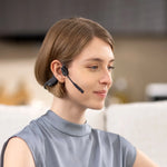 Woman wearing black Shokz OpenComm bone conduction headset with microphone boom
