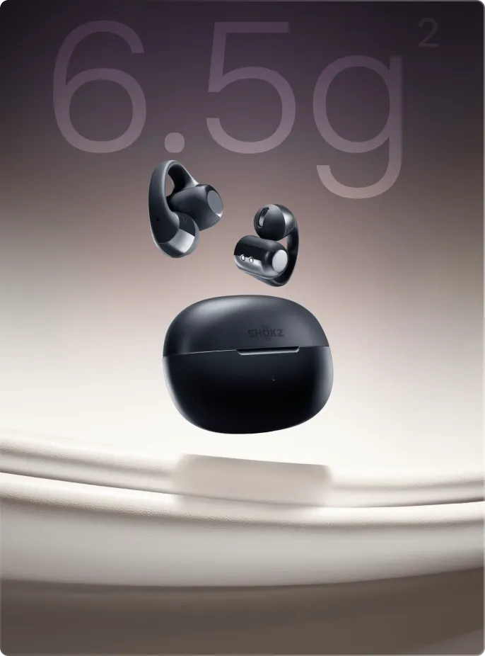 Shokz OpenDots ONE black wireless earbuds floating above charging case with gradient background