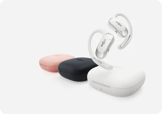 Shokz OpenFit Air earbuds with charging cases in pink, black and white colors
