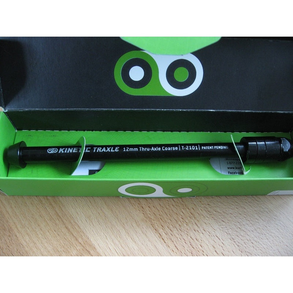 Kinetic Traxle 12mm thru-axle in black, displayed in green packaging box