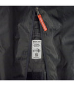 Interior detail of Patagonia Black Hole MLC Wheelie 34L showing repair label and zipper