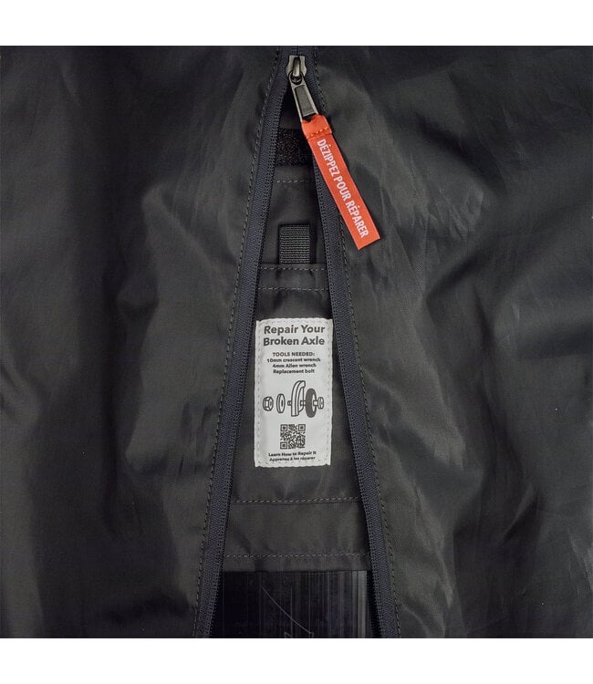 Interior detail of Patagonia Black Hole MLC Wheelie 34L showing repair label and zipper