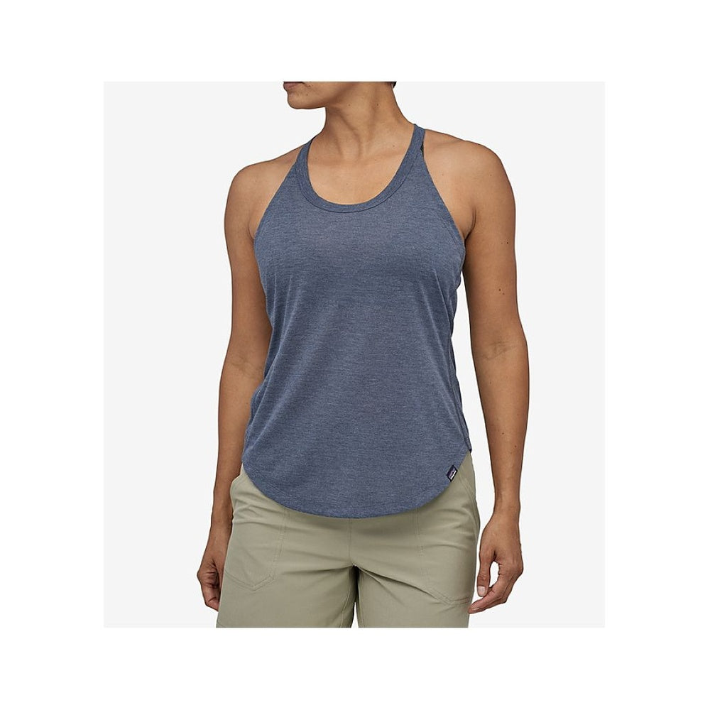 Woman wearing Patagonia heathered navy tank top with khaki shorts against white background