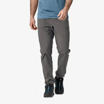 Man wearing Patagonia Quandary pants in forge grey with hiking boots
