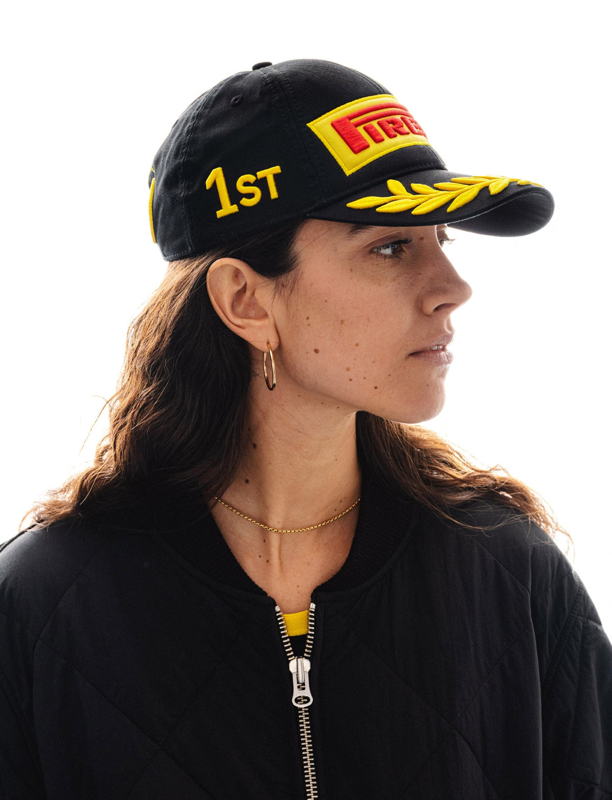 Pirelli black baseball cap with yellow 1st place and laurel wreath embroidery on model