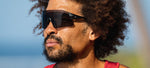 Man wearing Tifosi Rail BlackOut sunglasses with dark lenses outdoors