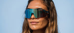 Woman wearing Tifosi Rail BlackOut sunglasses with mirrored lenses outdoors