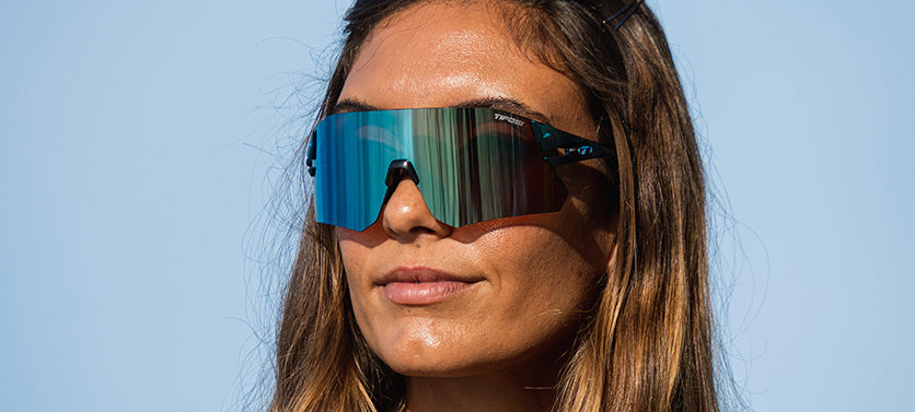 Woman wearing Tifosi Rail BlackOut sunglasses with mirrored lenses outdoors