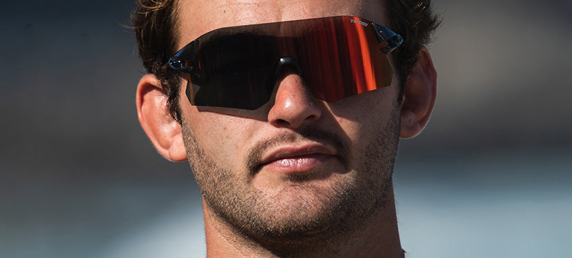 Man wearing Tifosi Rail BlackOut sunglasses with red lens and black frame