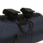 Close-up detail of black bicycle bar bag with velcro straps and D-ring attachments