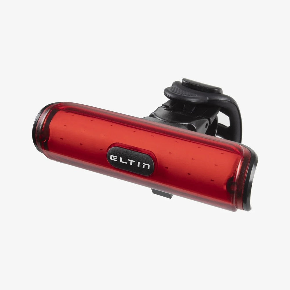 Red ELTIN rear bike light with black mounting clip on white background