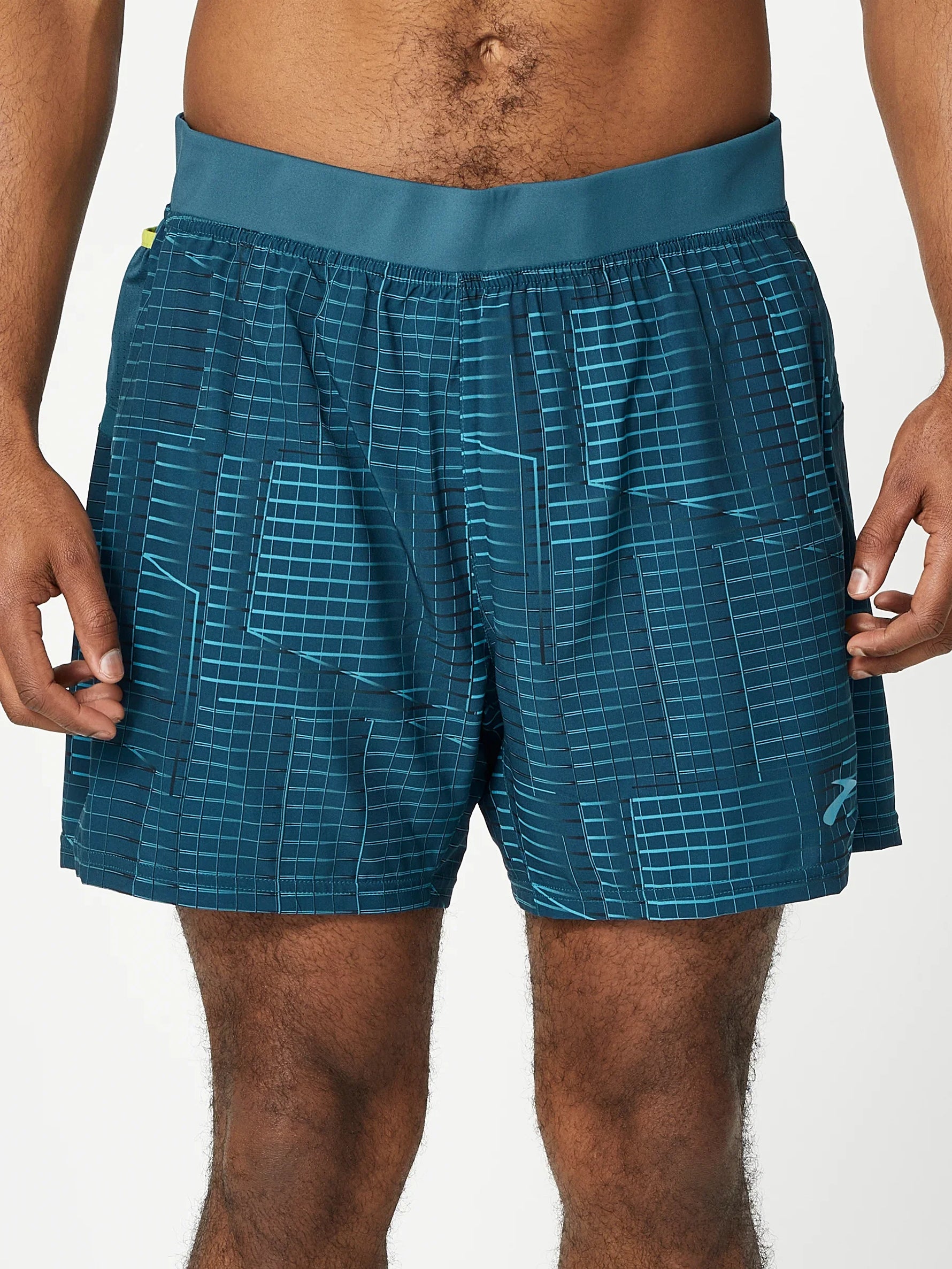 Brooks Sherpa 5-inch running shorts in teal with geometric pattern on model