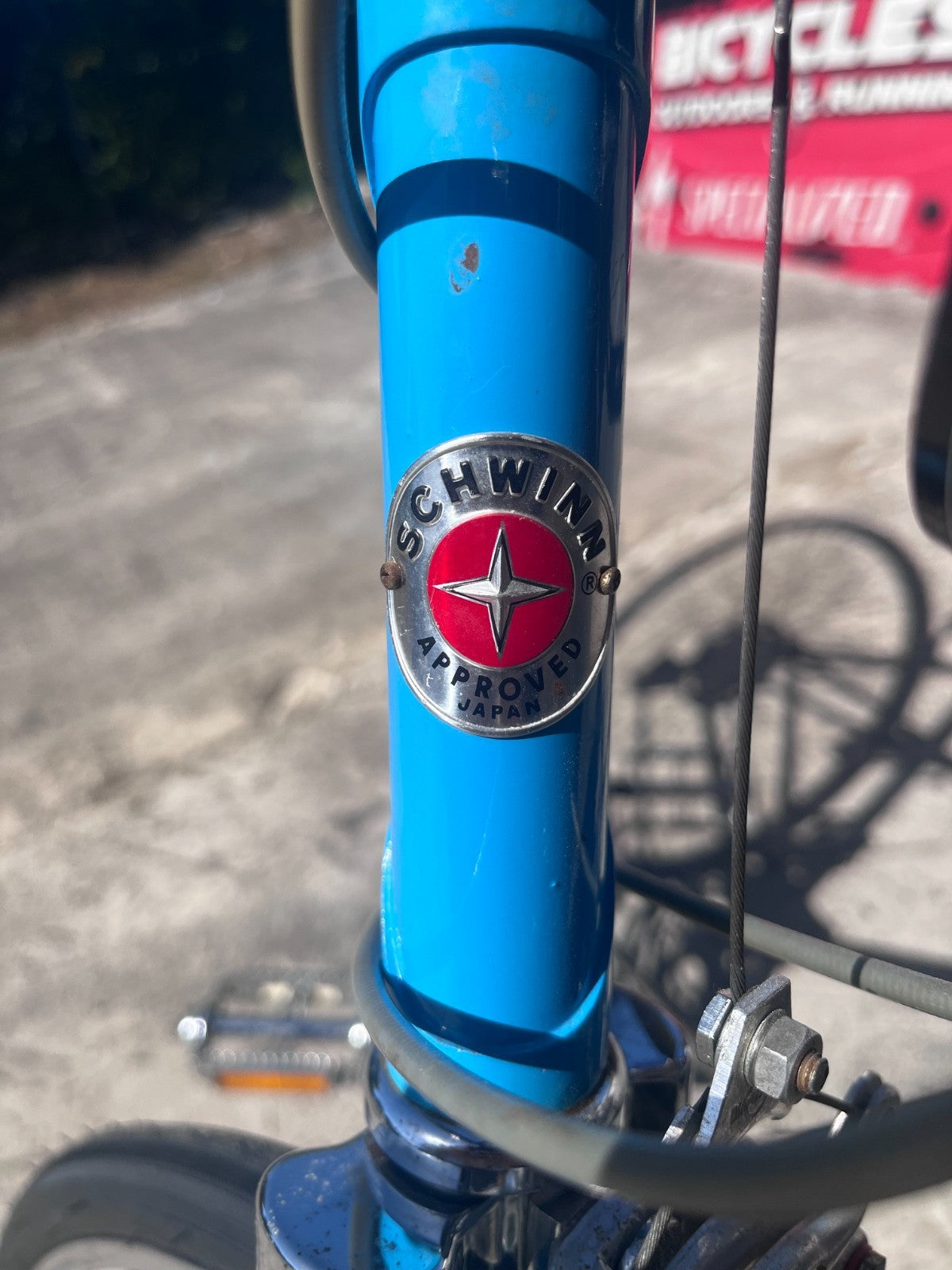 Schwinn head badge on the blue head tube of the vintage Le Tour Mixte bike