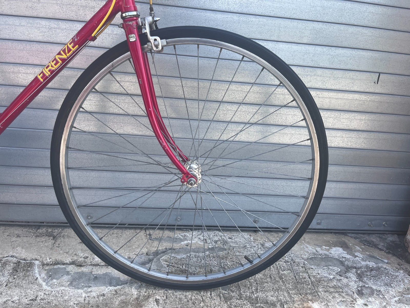 Front wheel and fork of the Firenze GL5000 showing the gold FIRENZE down tube decal