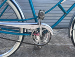 Chrome fenders and whitewall tires on vintage teal J.C. Higgins cruiser
