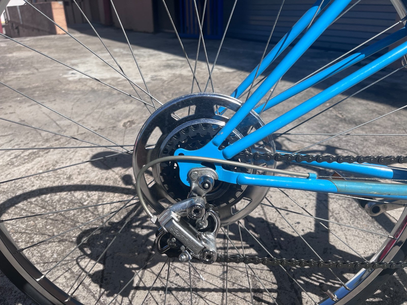 Rear derailleur, freewheel and chrome wheel detail on the Schwinn Le Tour Mixte