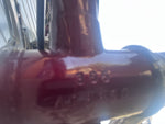 Macro view of a paint chip on the vintage SUTEKI bike frame showing steel underneath