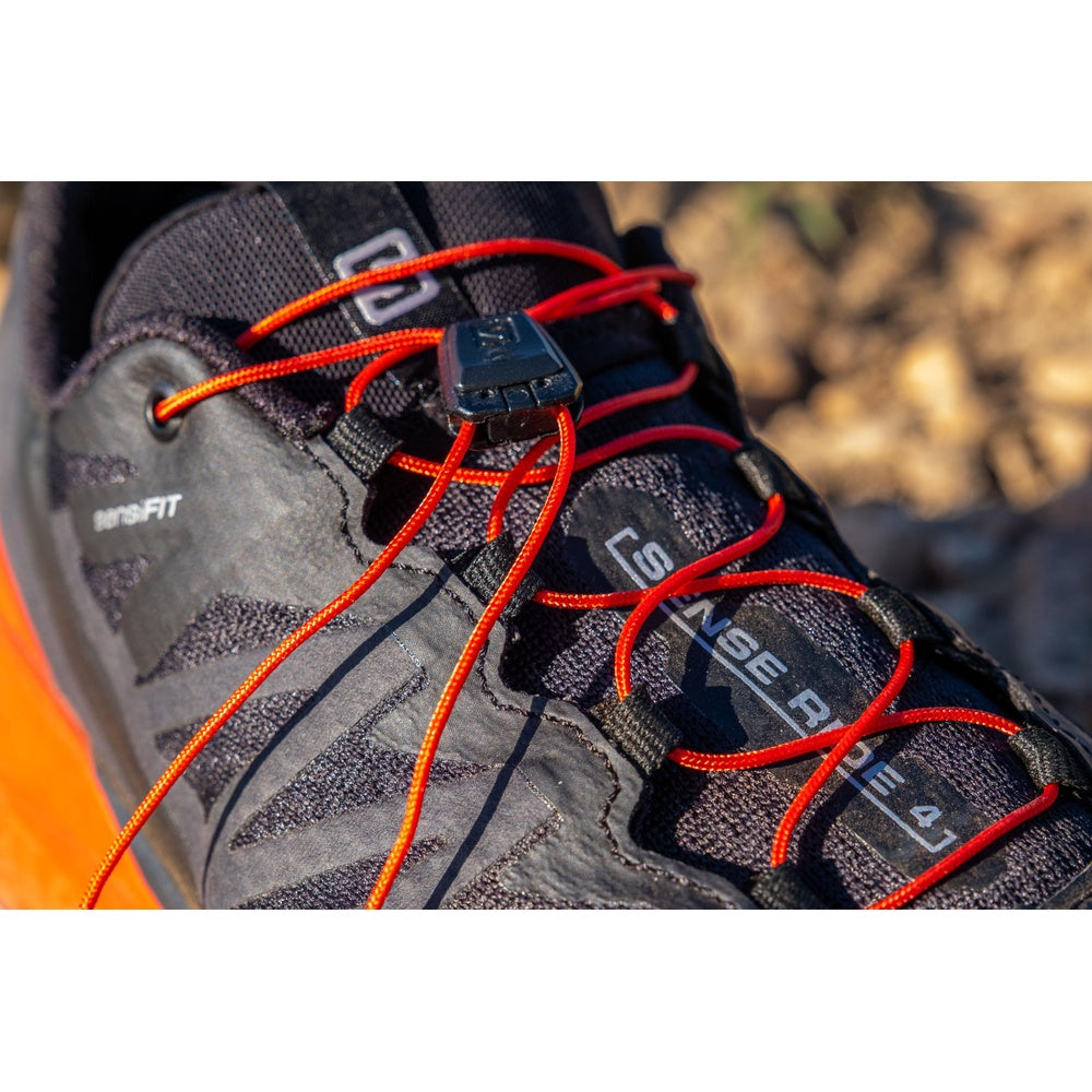 Salomon Sense Ride 4 trail running shoe in black with orange lacing system