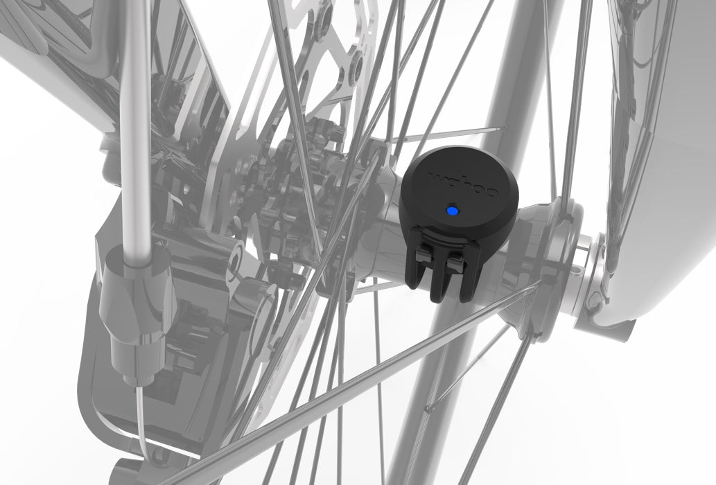 Black Wahoo speed sensor attached to bicycle wheel spokes