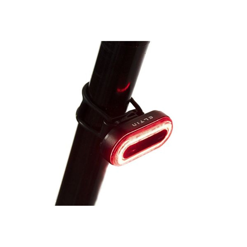 Black Eltin rear bike light mounted on seatpost with red LED illuminated