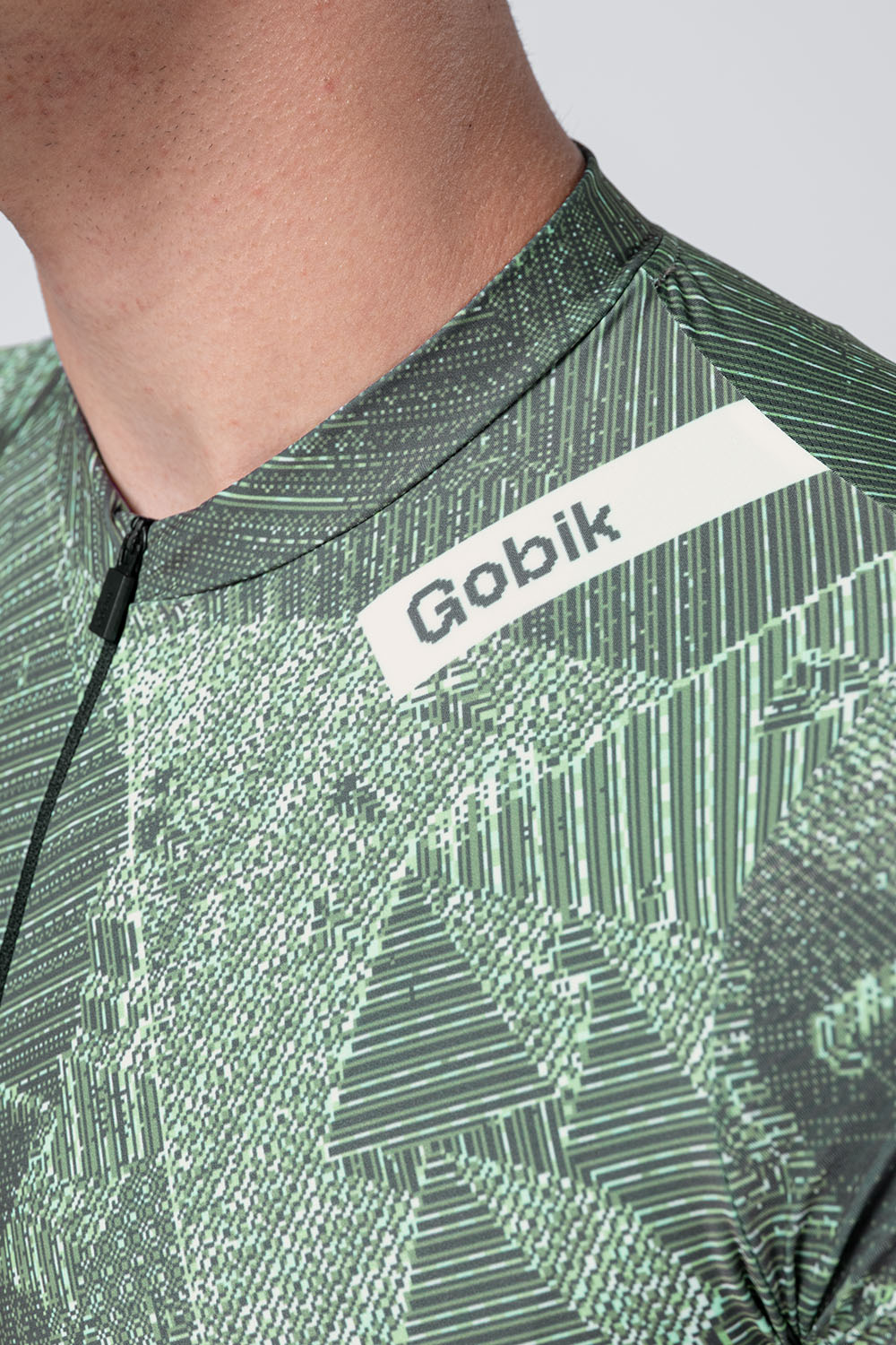 Gobik Attitude 2.0 short sleeve cycling jersey in Crash green geometric pattern with matching shorts