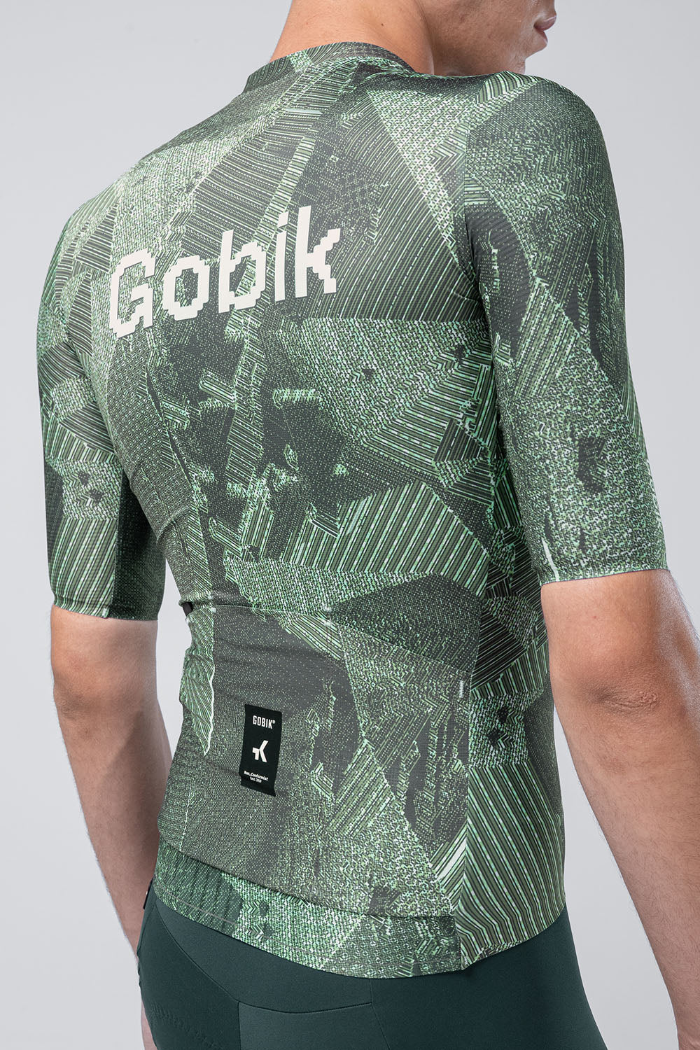 Gobik Attitude 2.0 short sleeve cycling jersey in Crash colorway with geometric green pattern