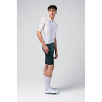 Male model wearing white Gobik Miami Attitude cycling jersey with green shorts