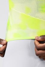 Close-up detail of Gobik Carrera 3.0 neon yellow jersey hem and mesh fabric texture