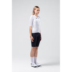 Female cyclist wearing white Gobik Carrera 3.0 jersey with black shorts in studio