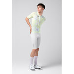 Male cyclist wearing white and lime green Gobik CX Pro jersey with matching shorts