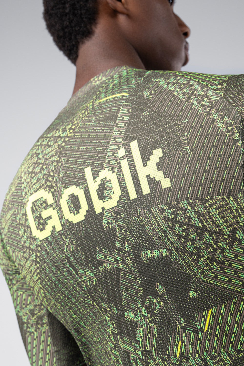Gobik cycling jersey with green circuit board grid pattern worn by model