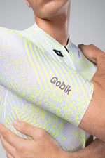 Gobik CX Pro Jersey in white with neon yellow pattern worn by cyclist