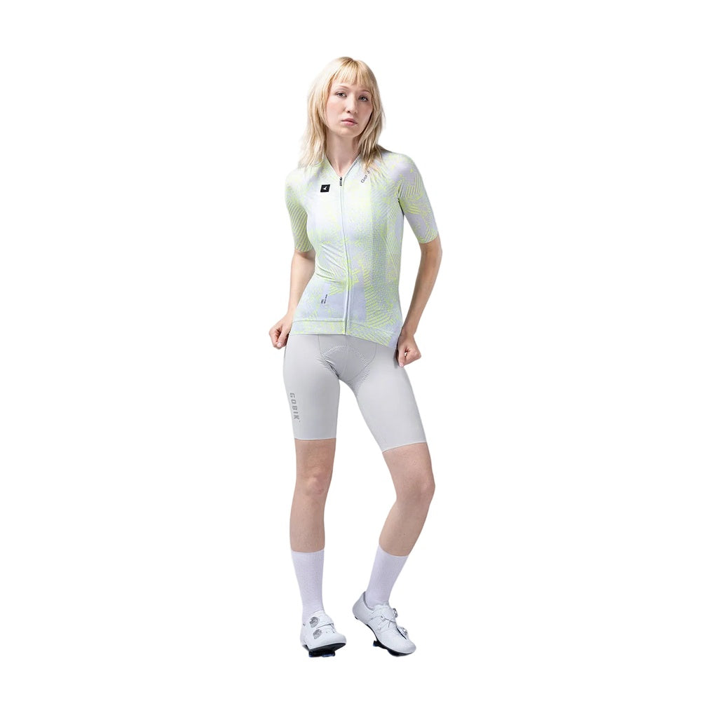 Woman wearing Gobik cycling jersey with neon yellow pattern and gray shorts