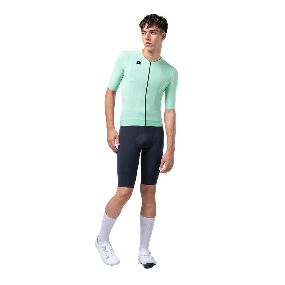 Male model wearing Gobik CX Solid short sleeve cycling jersey in mint green with navy shorts