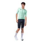 Male model wearing Gobik CX Solid short sleeve cycling jersey in mint green with navy shorts