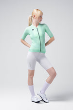 Woman wearing Gobik CX Solid mint green cycling jersey with white shorts