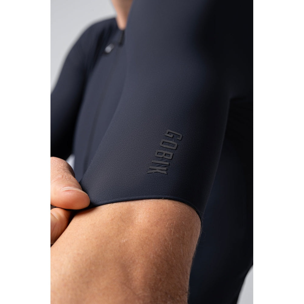 Close-up of Gobik CX cycling jersey sleeve showing embossed brand logo detail