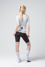 Female model wearing Gobik CX Solid short sleeve cycling jersey in Empire gray with black shorts