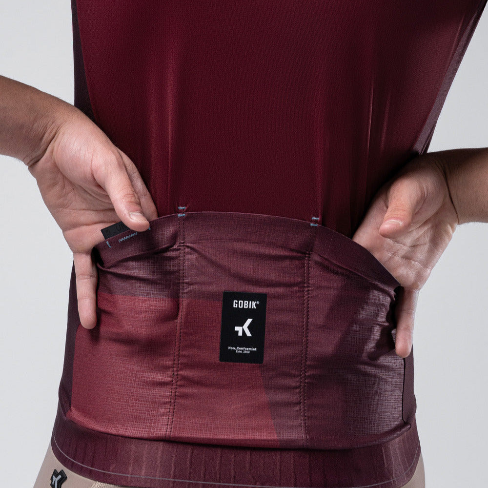 Gobik Magnitude cycling jersey in burgundy showing back pocket detail with brand label